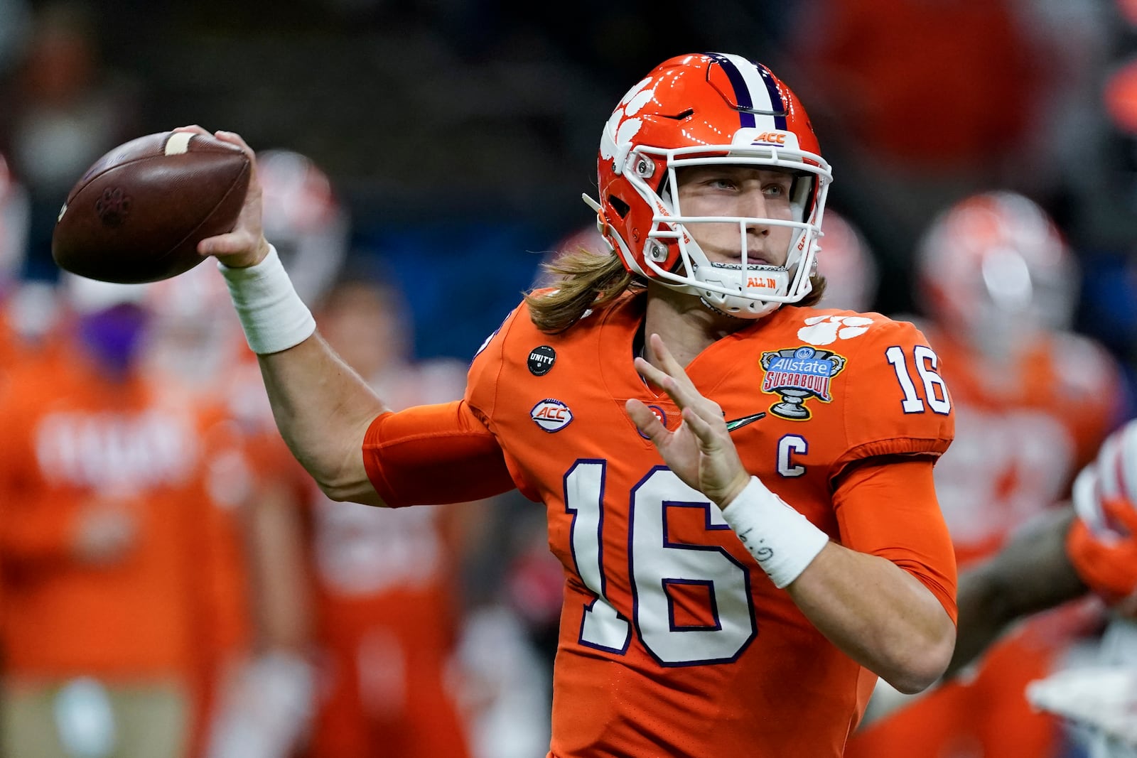 FILE - In this Friday, Jan. 1, 2021 file photo, Clemson quarterback Trevor Lawrence passes against Ohio State during the first half of the Sugar Bowl NCAA college football game in New Orleans. The last NFL event not impacted by the COVID-19 pandemic was the 2020 combine in Indianapolis. A year later, with the 2021 combine canceled, the league has released a list of players who would have merited invitations. From such high-profile quarterbacks as Clemson’s Trevor Lawrence and Ohio State’s Justin Fields to guys who sat out last season such as Oregon tackle Penei Sewell, there are 323 players from 100 schools.  (AP Photo/John Bazemore, File)