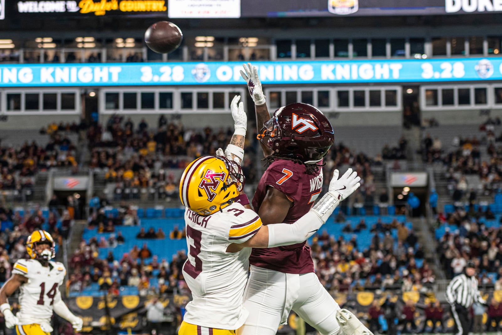 Virginia Tech wide receiver Chanz Wiggins (7) is defended by Minnesota defensive back Koi Perich (3) during the first half of the Duke's Mayo Bowl NCAA college football game Friday, Jan. 3, 2025, in Charlotte, N.C. (AP Photo/Robert Simmons)