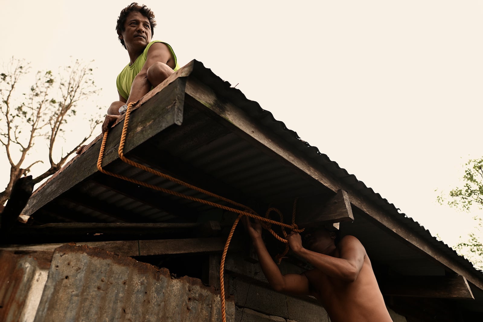 Residents reinforce the roof of their house in Santa Ana, Cagayan Province, northern Philippines as they anticipate Typhoon Usagi to hit their area Thursday, Nov. 14, 2024. (AP Photo/Noel Celis)