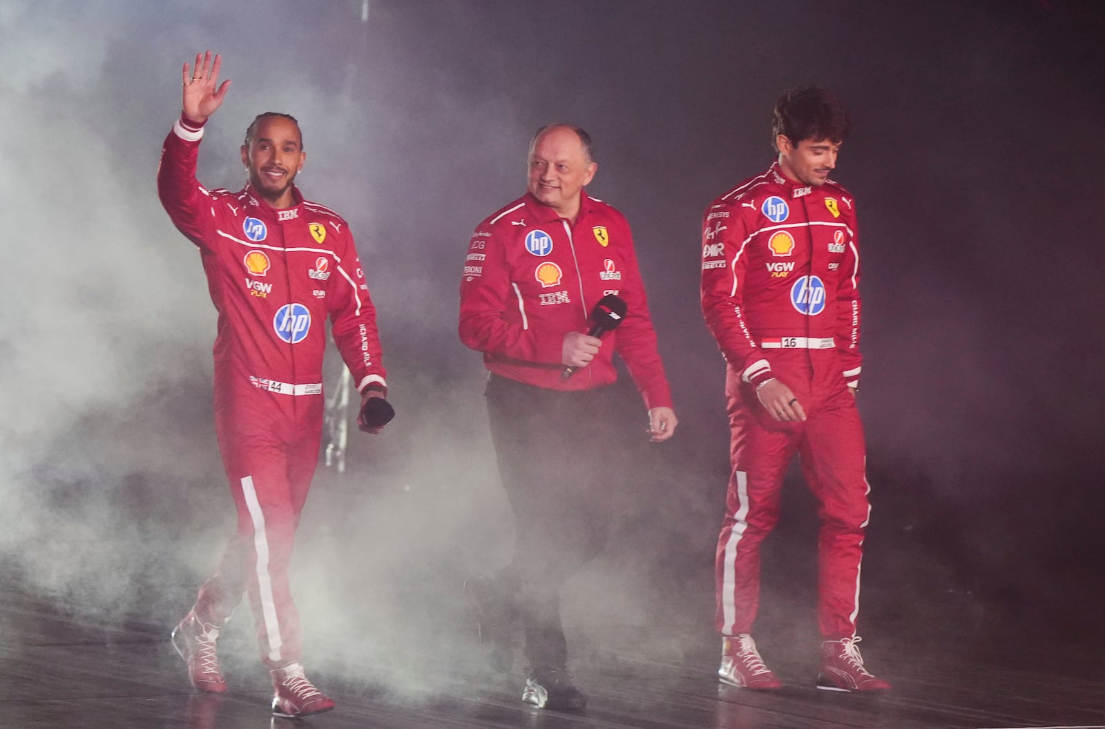 Ferrari drivers Charles Leclerc, right, and Lewis Hamilton, left, with team principal Fred Vasseur, center, during the F1 75 Live event at the O2 arena in London, England, Tuesday, Feb. 18, 2025.(Bradley Collyer/PA via AP)