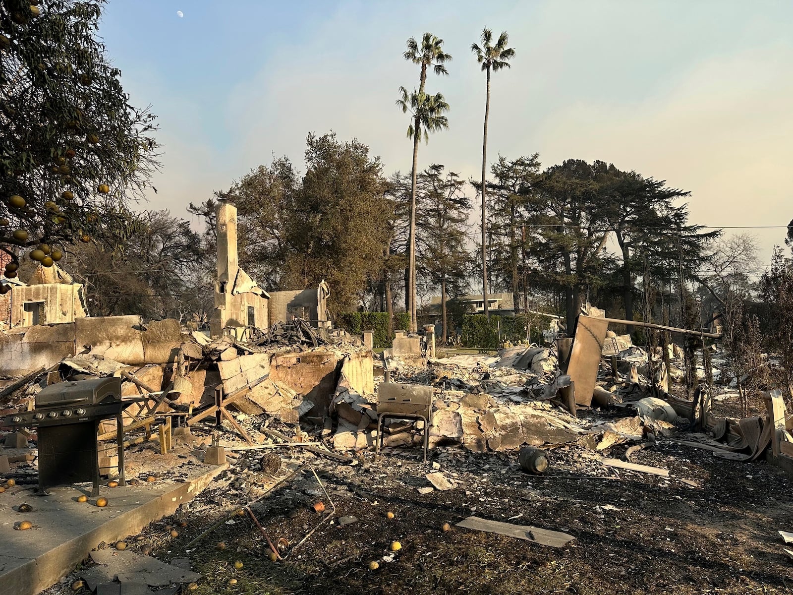 In this photo provided by Darin Bresnitz, a grill is among the remnants of the burned home of him and his wife, Anna Yeager, on Thursday, Jan. 9, 2025, after a fire swept through their Altadena, Calif., neighborhood. (Darin Bresnitz via AP)