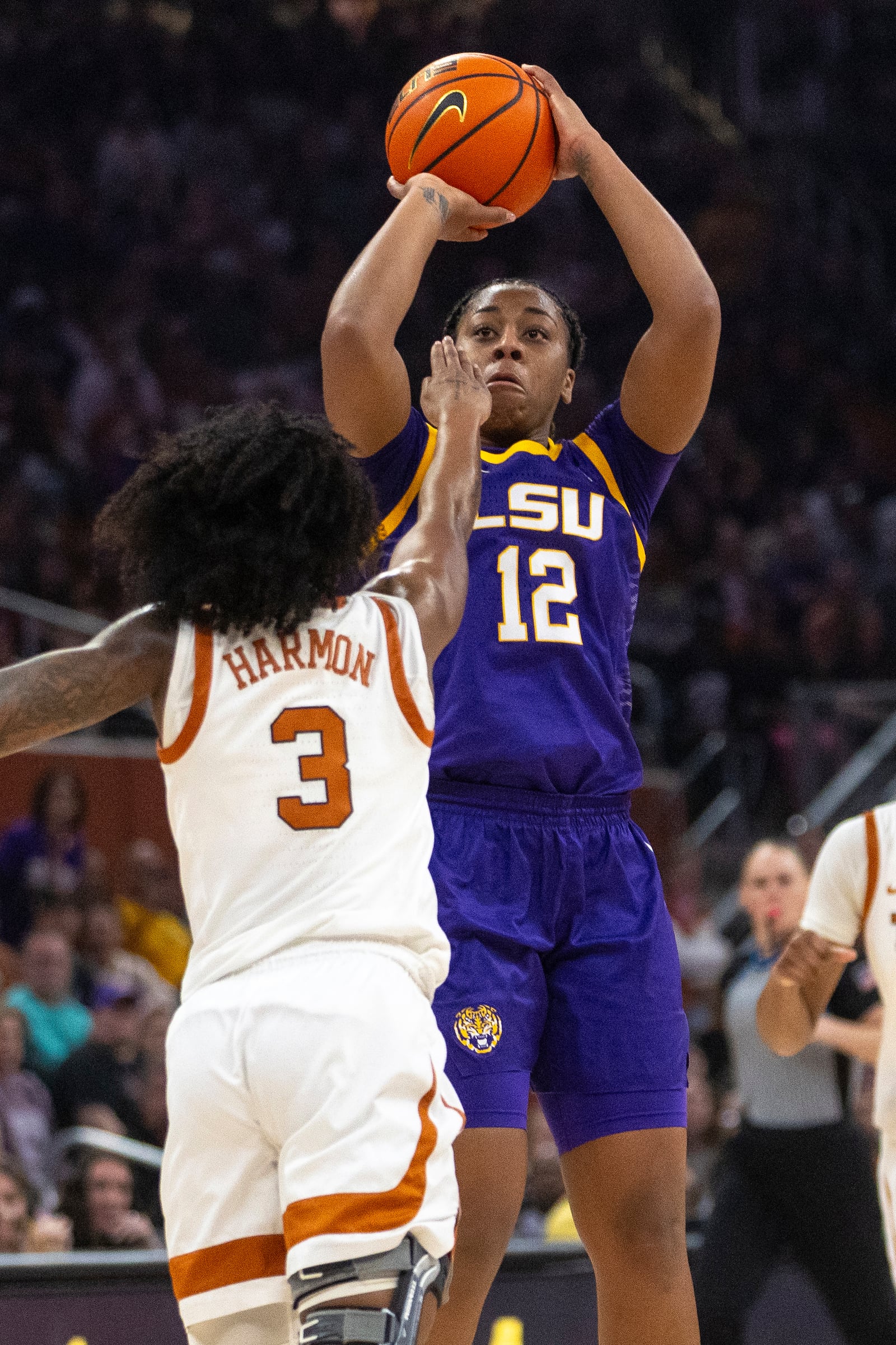 LSU guard Mikaylah Williams (12) shoots over Texas guard Rori Harmon (3) during the first half of an NCAA college basketball game in Austin, Texas, Sunday, Feb. 16, 2025. (AP Photo/Stephen Spillman)