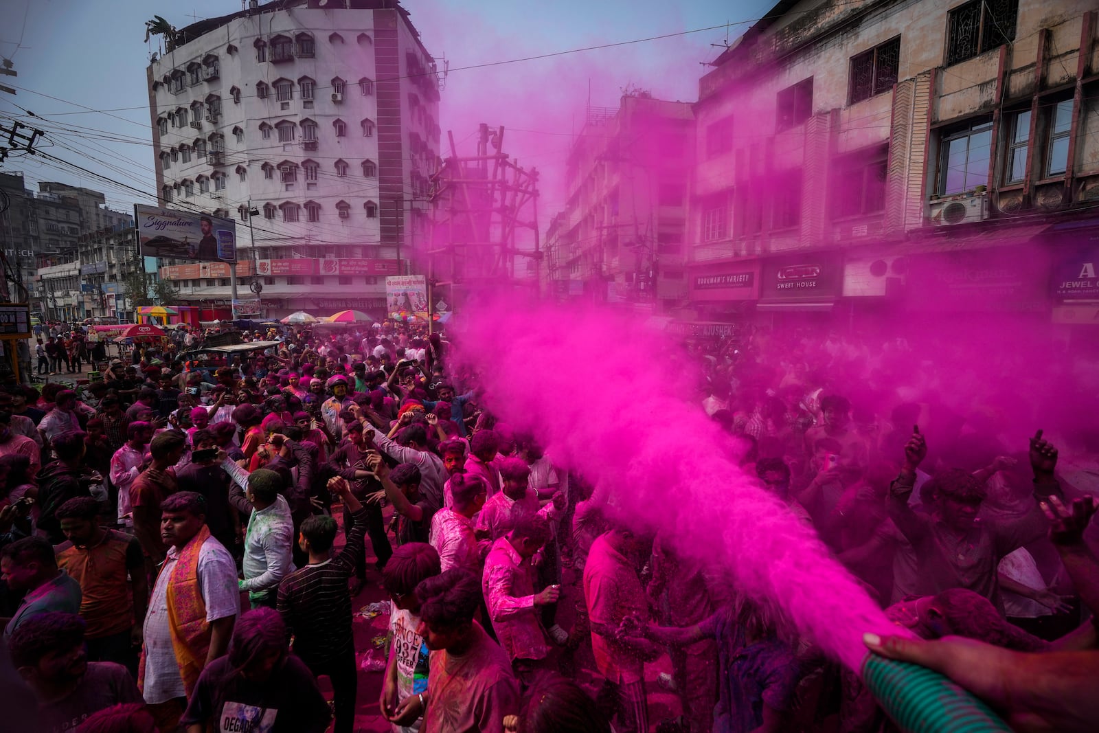 Indians dance as they celebrate Holi in Guwahati, India, Friday, March 14, 2025. (AP Photo/Anupam Nath)