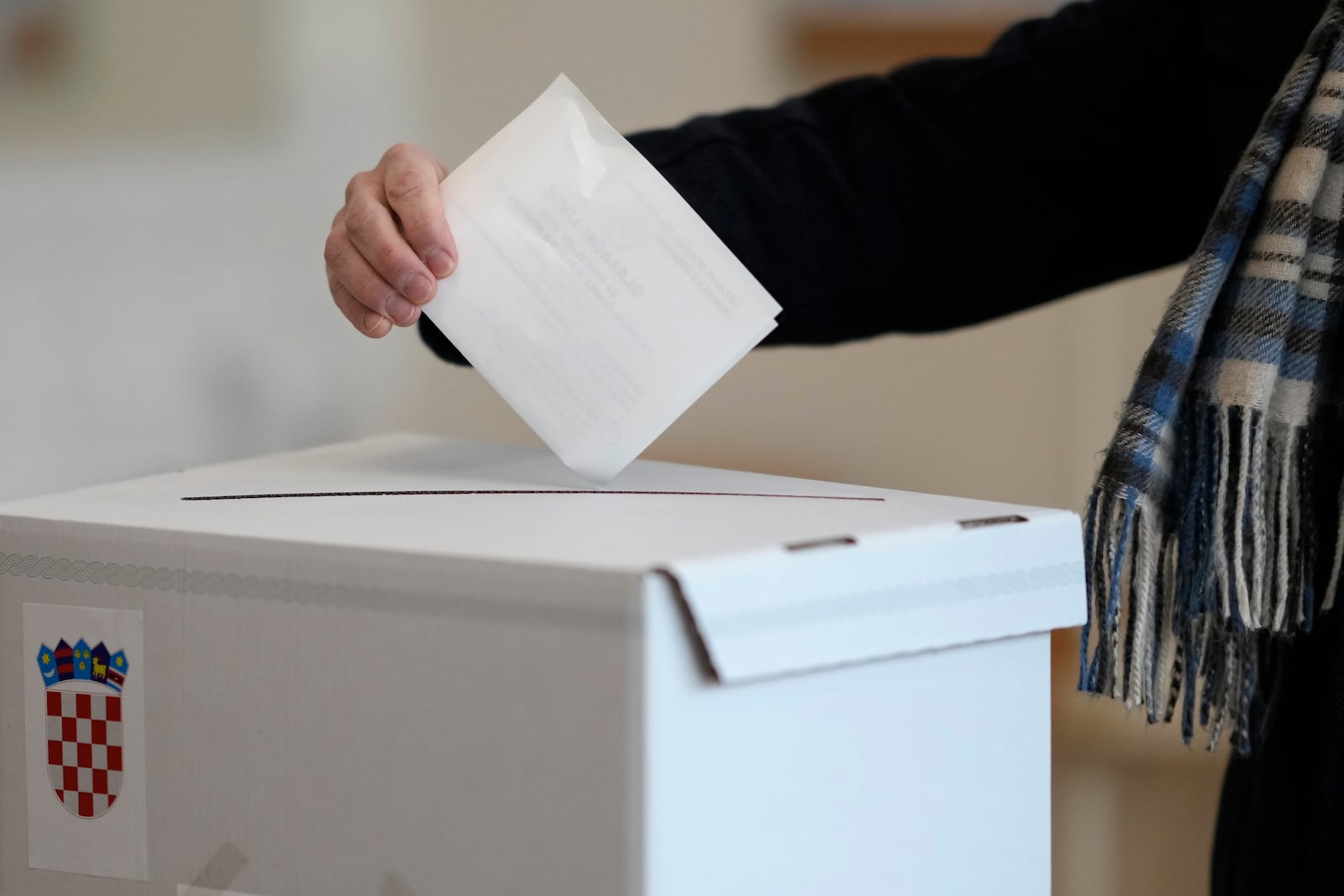 A resident casts his ballot during a runoff vote for the Croatian presidential election at a polling station in Zagreb, Croatia, Sunday, Jan. 12, 2025. (AP Photo/Darko Bandic)