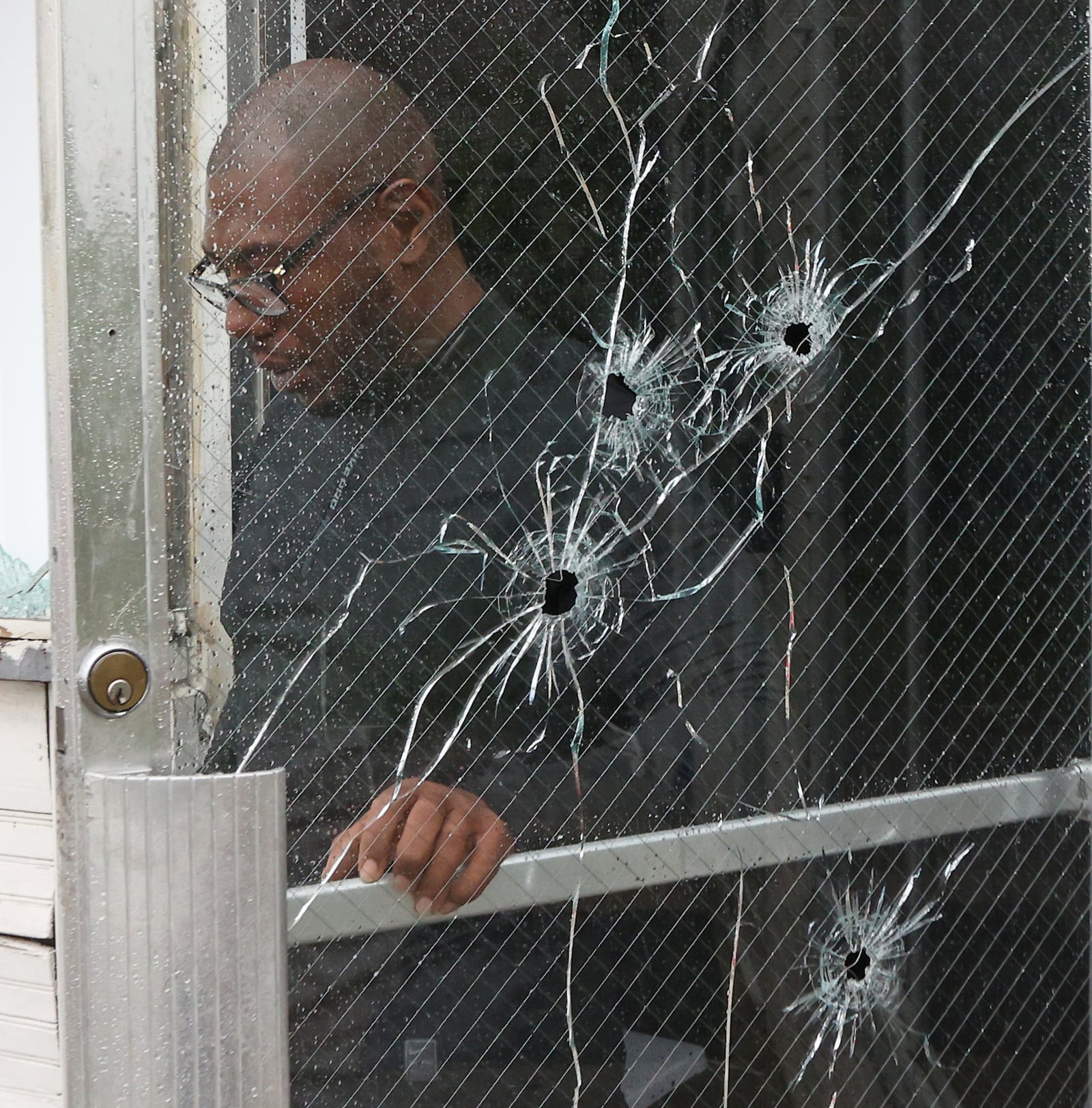 Glen Williams, the owner of the business on South Yellow Springs Street where six people were shot early Wednesday morning, walks out of his business after surveying the damage. BILL LACKEY/STAFF