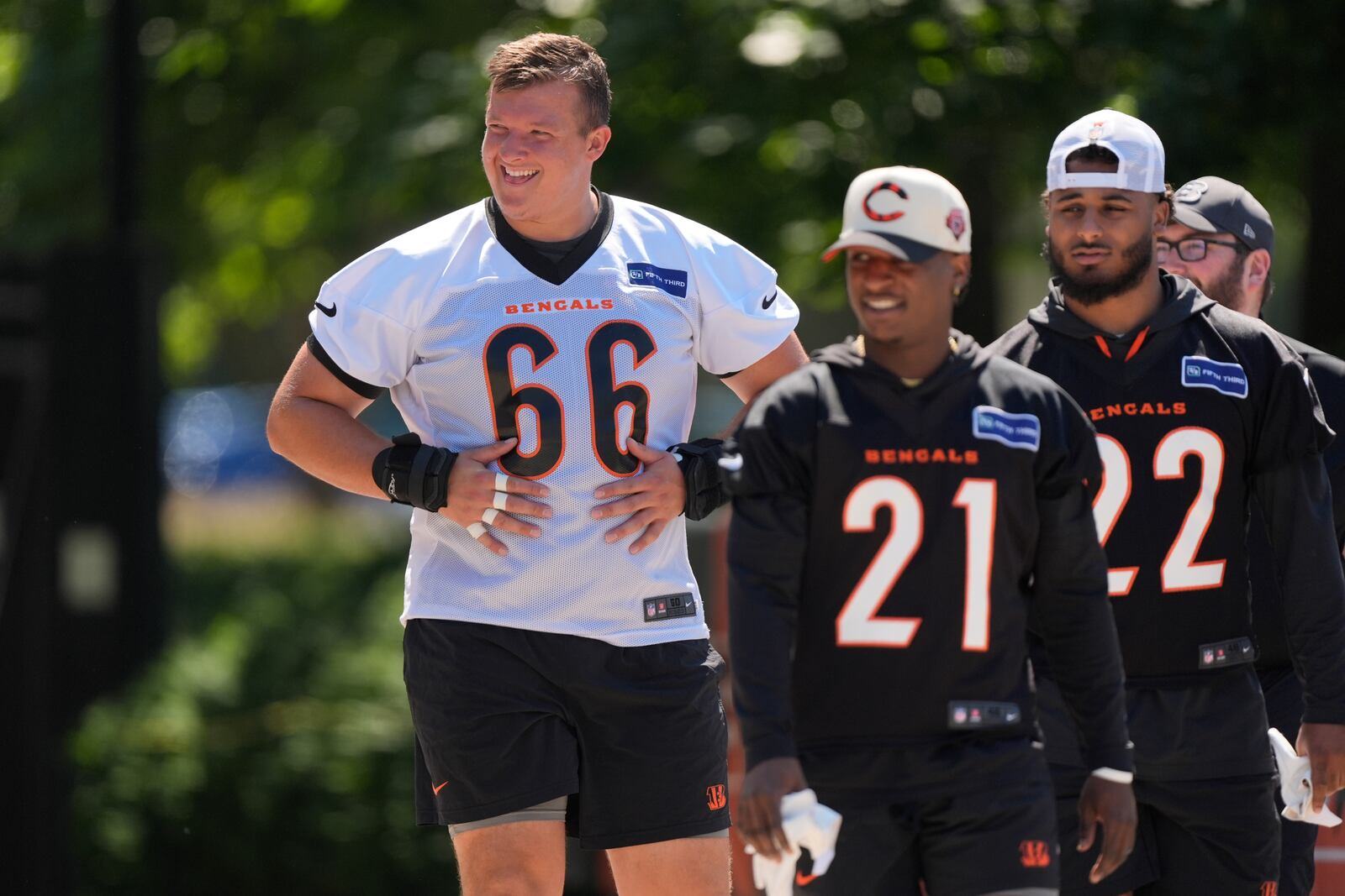 Cincinnati Bengals center Nate Gilliam (66), cornerback Mike Hilton (21), and safety Geno Stone (22) look to fans as they walk to NFL football practice on Tuesday, May 21, 2024, in Cincinnati. (AP Photo/Carolyn Kaster)