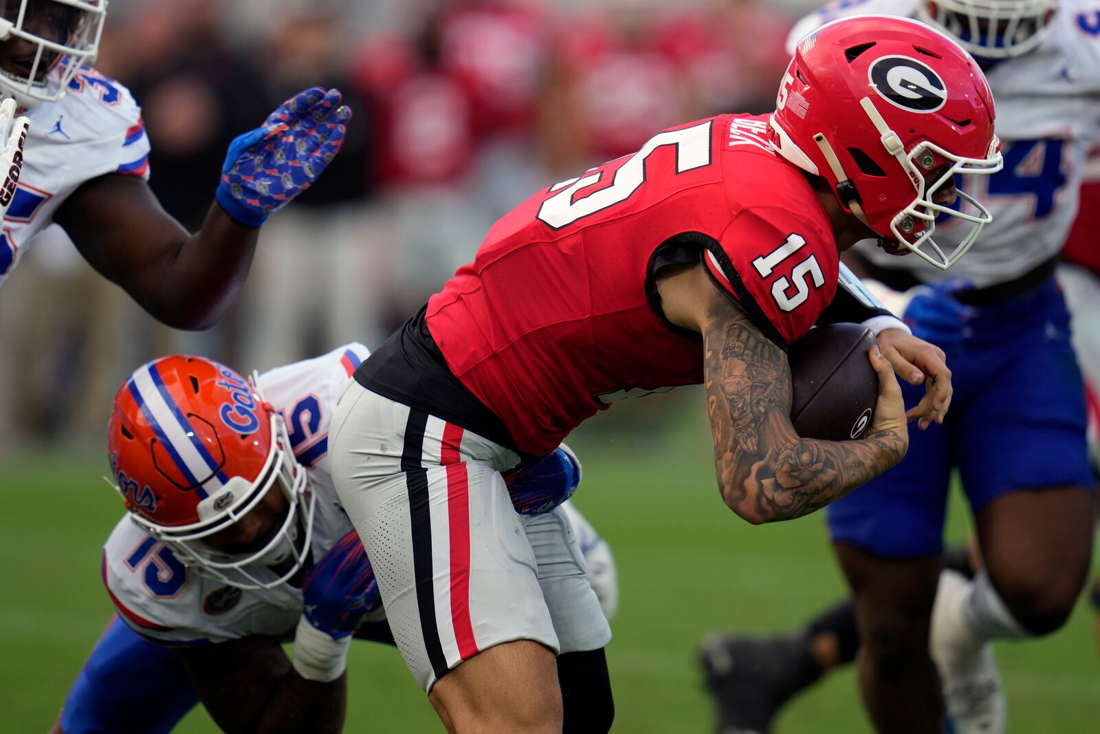 Florida linebacker Derek Wingo, left, sacks Georgia quarterback Carson Beck, right, during the first half of an NCAA college football game, Saturday, Nov. 2, 2024, in Jacksonville, Fla. (AP Photo/John Raoux)