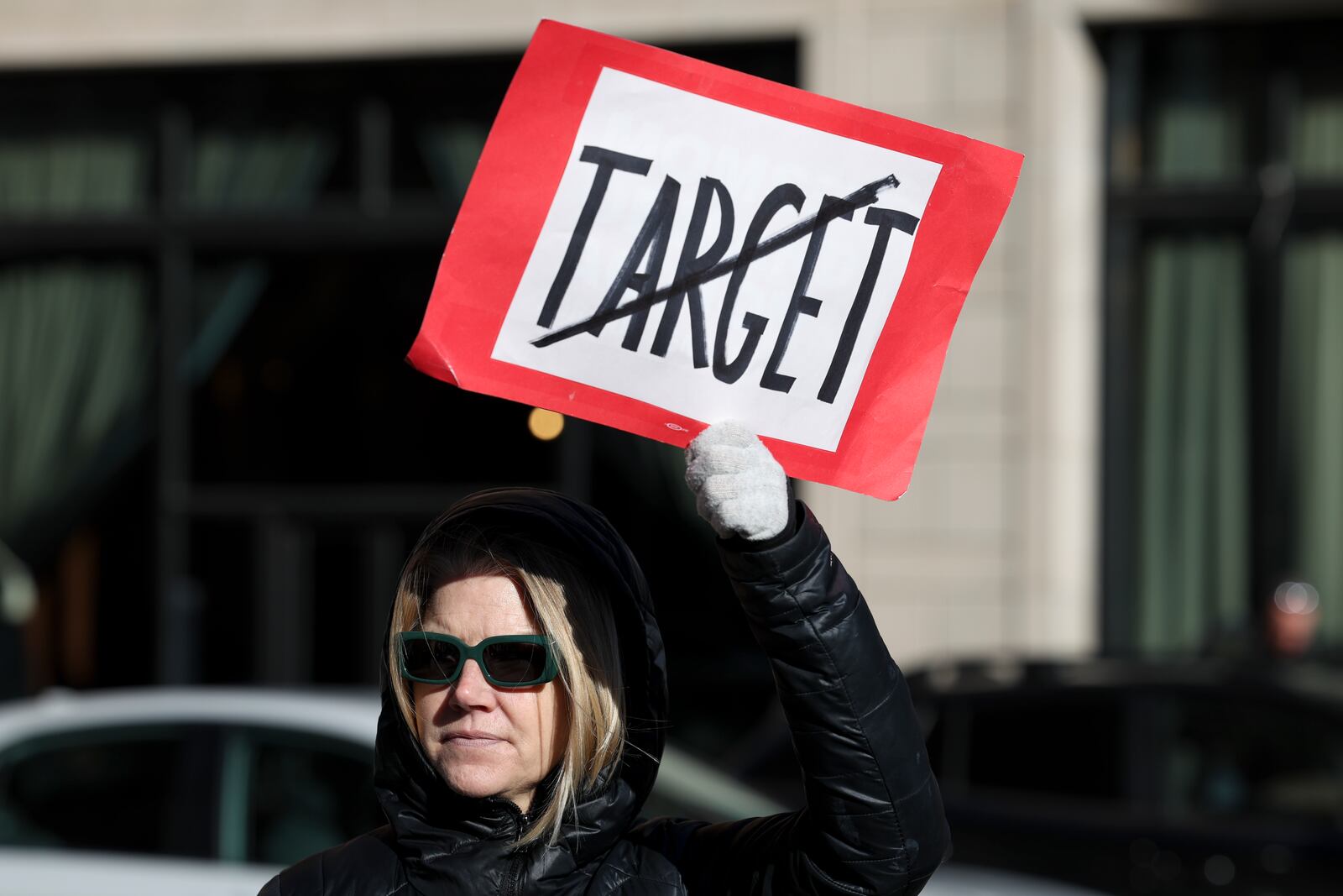 Becky Dankowski, center, of Minneapolis, who said she was a long-time customer, holds an anti-Target sign during a news conference outside Target Corporation's headquarters Thursday, Jan. 30, 2025, in Minneapolis, Minn. (AP Photo/Ellen Schmidt)