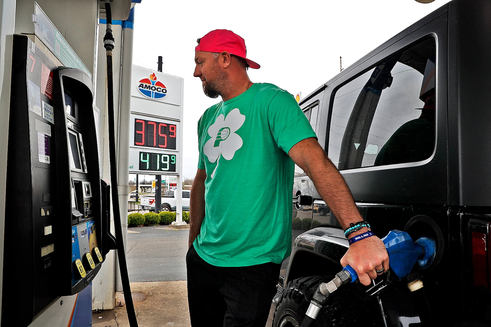 Brad Humble fills up his Jeep Thursday, April 6, 2023 at the AMOCO gas station at the intersection of South Limestone Street and Leffel Lane in Springfield. BILL LACKEY/STAFF