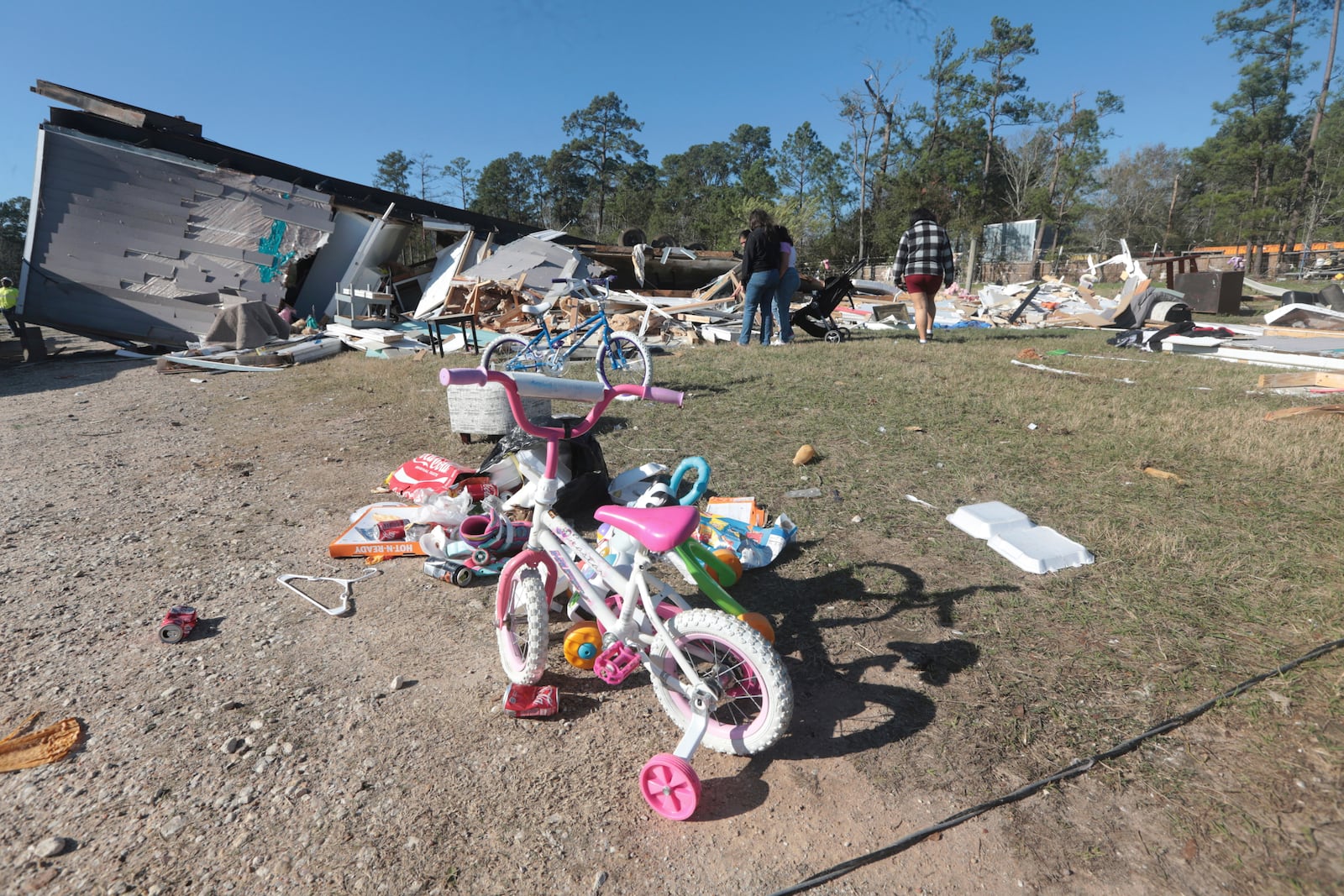 Residents in Conroe, Texas, survey damage Monday, Dec. 30, 2024, following a strong weekend storm system that spawned hail, rain, high winds and tornadoes across the southern U.S. (AP Photo/Lekan Oyekanmi)