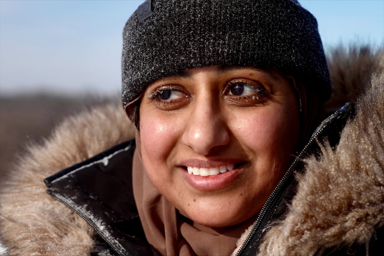 Ruqayah Nasser takes a break after her first snow tubing runs in below-zero cold during an outing organized by a Minnesota group promoting outdoors activities by Muslim women, at Elm Creek Park Reserve in Maple Grove, Minn., on Jan. 4, 2025. (AP Photo/Mark Vancleave)