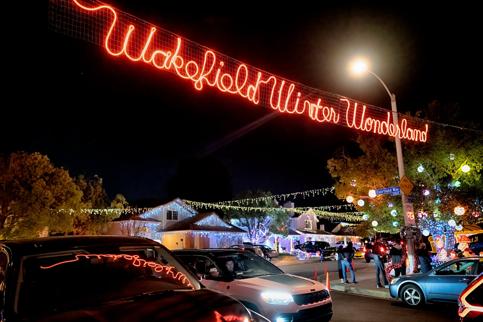 Local residents drive through the Wakefield Winter Wonderland neighborhood decorated with Christmas lights in Santa Clarita, Calif. on Dec. 17, 2024. (AP Photo/Richard Vogel)