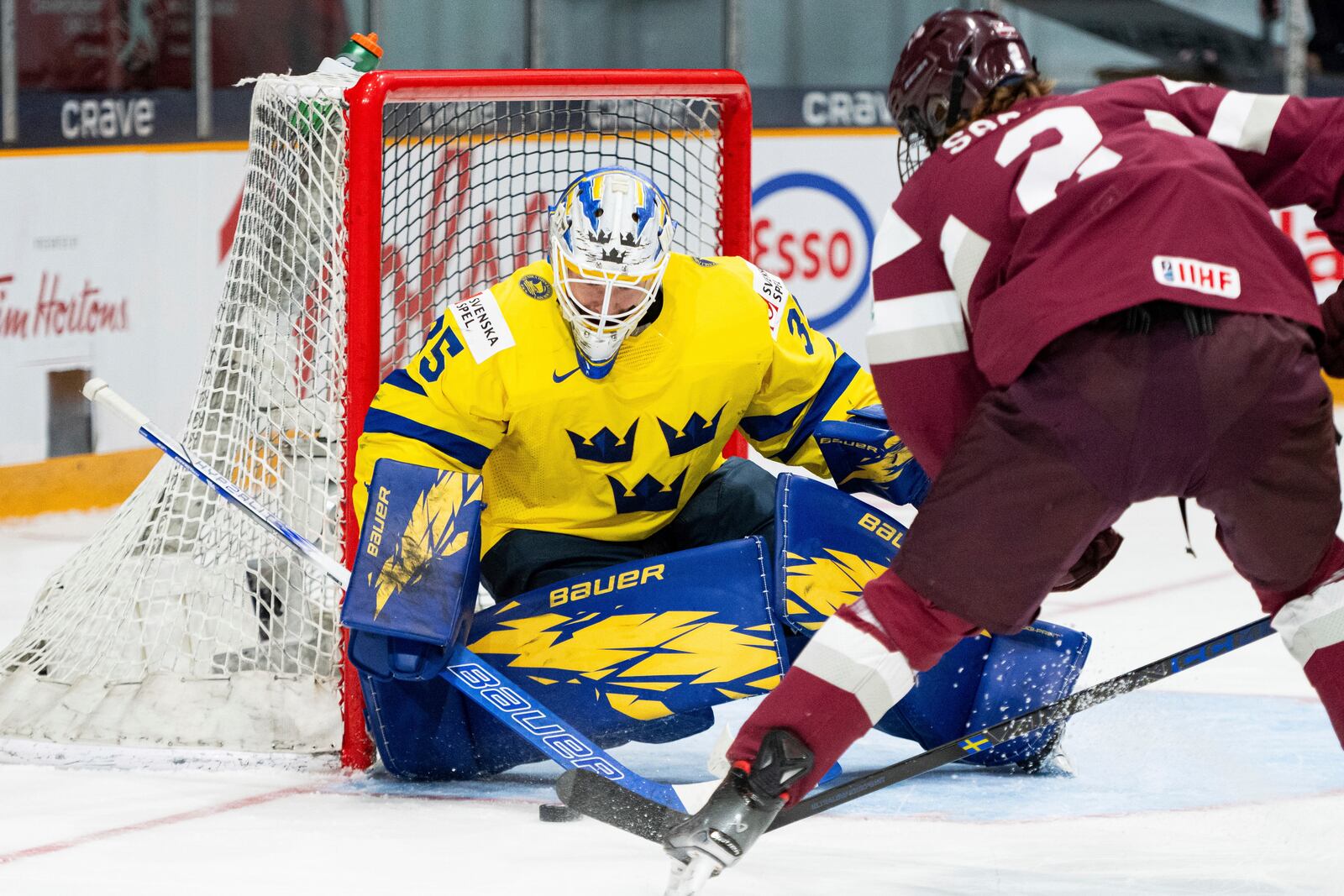 Team Latvia defenseman Krisjanis Sarts (2) takes a shot on Team Sweden goaltender Melker Thelin (35) during the first period of an IIHF World Junior Hockey Championship quarterfinal match in Ottawa, Ontario Thursday, Jan. 2, 2025. (Spencer Colby/The Canadian Press via AP)