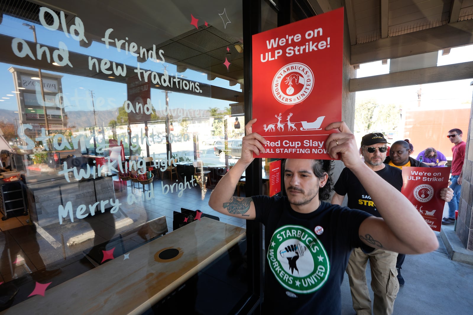 Starbuck workers picket outside of a closed Starbucks on Friday, Dec. 20, 2024, in Burbank, Calif. (AP Photo/Damian Dovarganes)