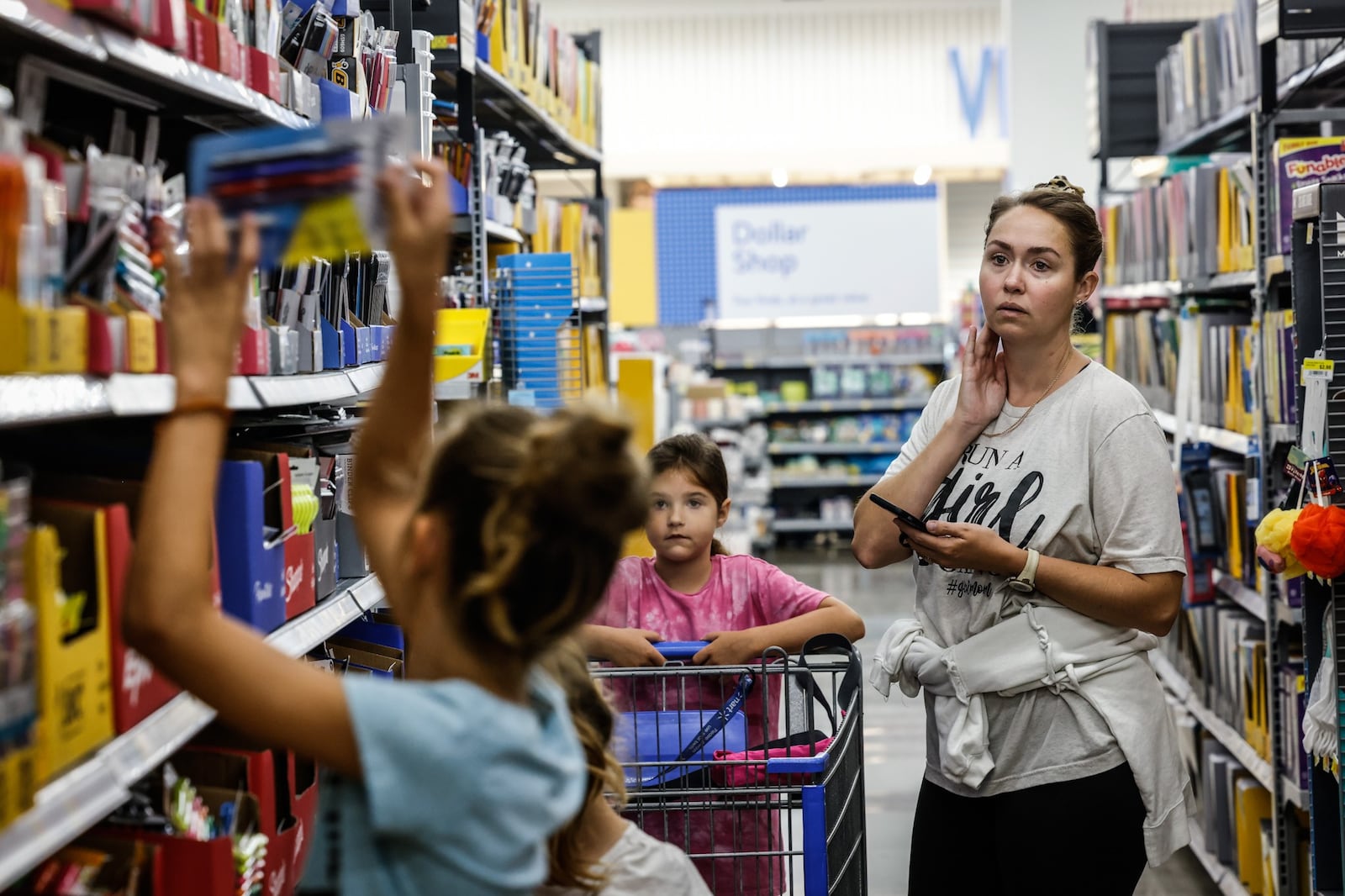 Natalie Folino, from Waynesville shop for school supplies with her three daughters, Genevieve, Giselle and Bianca at the Super Walmart on Wilmington Pike Thursday July 28, 2022. Ohio’s sales tax holiday on school supplies, instructional material and clothes runs from noon Aug. 5 to 11:59 p.m. Aug. 7. Exempt from sales and use tax during the holiday are items of clothing priced at $75 or less, items of school supplies priced at $20 or less and items of school instructional material priced at $20 or less. JIM NOELKER/STAFF