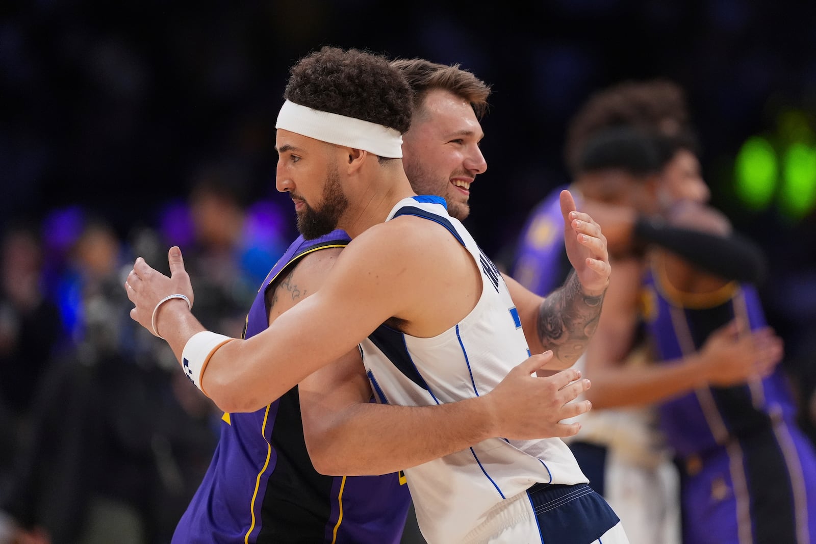 Los Angeles Lakers guard Luka Doncic, left, and Dallas Mavericks guard Klay Thompson hug before an NBA basketball game Tuesday, Feb. 25, 2025, in Los Angeles. (AP Photo/Mark J. Terrill)