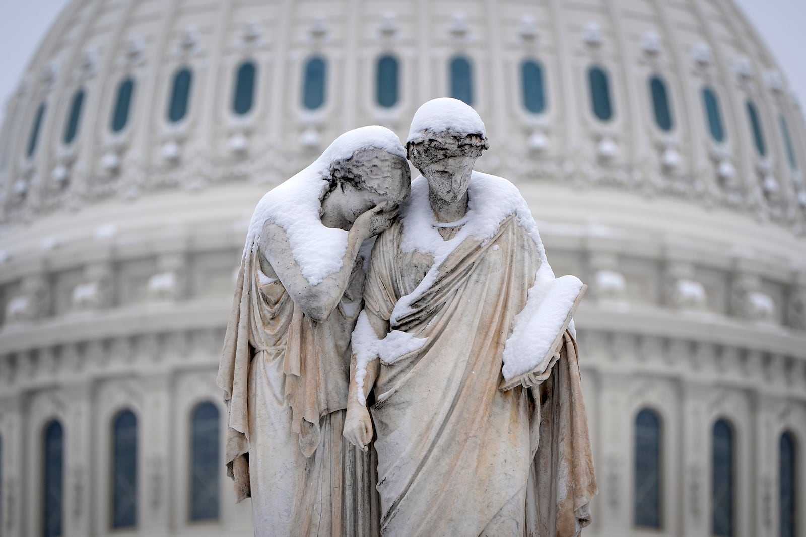 FILE - The Peace Monument, also known as the Naval Monument or Civil War Sailors Monument, is covered with snow outside the Capitol, Feb. 12, 2025, after a snowstorm in Washington. (AP Photo/Jacquelyn Martin, Flie)