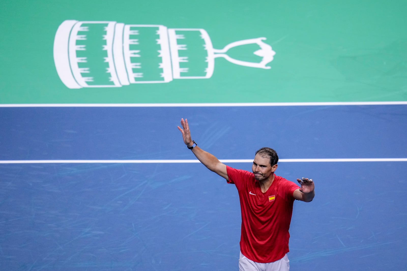 Spain's tennis player Rafael Nadal waves to the crowd after losing against Netherlands' Botic Van De Zandschulp during a Davis Cup quarterfinal match at Martin Carpena Sports Hall in Malaga, southern Spain, on Tuesday, Nov. 19, 2024. (AP Photo/Manu Fernandez)