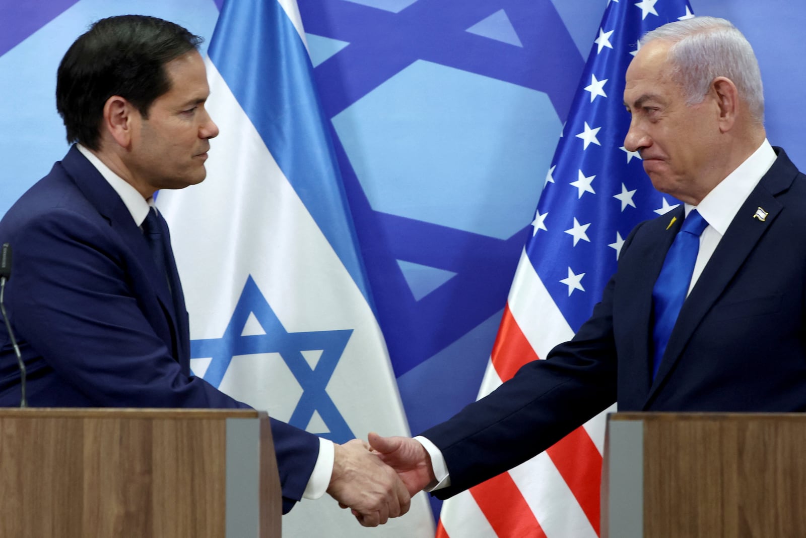 U.S. Secretary of State Marco Rubio, left, and Israeli Prime Minister Benjamin Netanyahu shake hands during a news conference at the Prime Minister's office in Jerusalem, Israel, Sunday, Feb. 16, 2025. (Evelyn Hockstein/Pool Photo via AP)