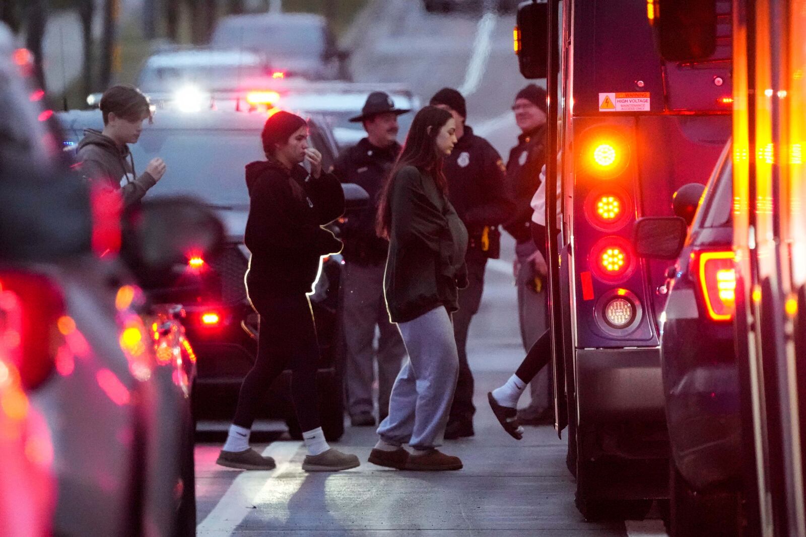 Students aboard a bus as they leave the shelter following a shooting at the Abundant Life Christian School, Monday, Dec. 16, 2024. (AP Photo/Morry Gash)