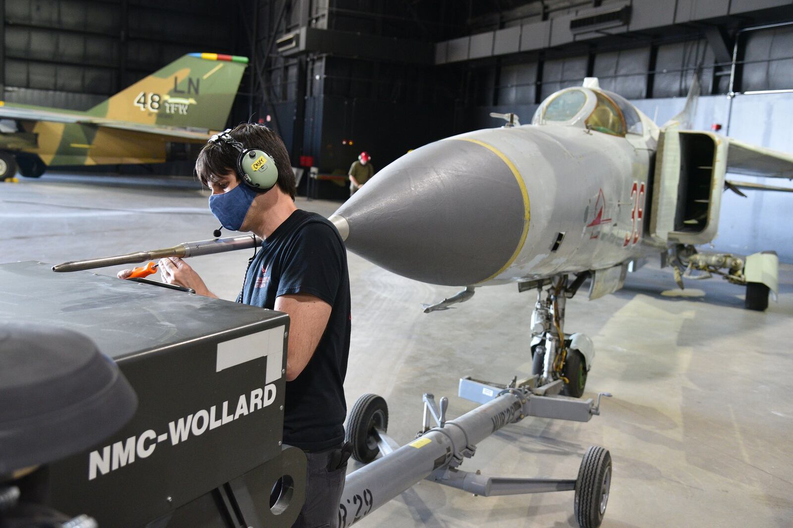 Museum restoration specialist Casey Simmons works on the Mikoyan-Gurevich MiG-23MS “Flogger-E” during the Cold War Gallery aircraft moves. These moves are intended to better tell the story of the Cold War and post-Cold War, as well as provide new views of the aircraft in these galleries. CONTRIBUTED/U.S. AIR FORCE/KEN LAROCK