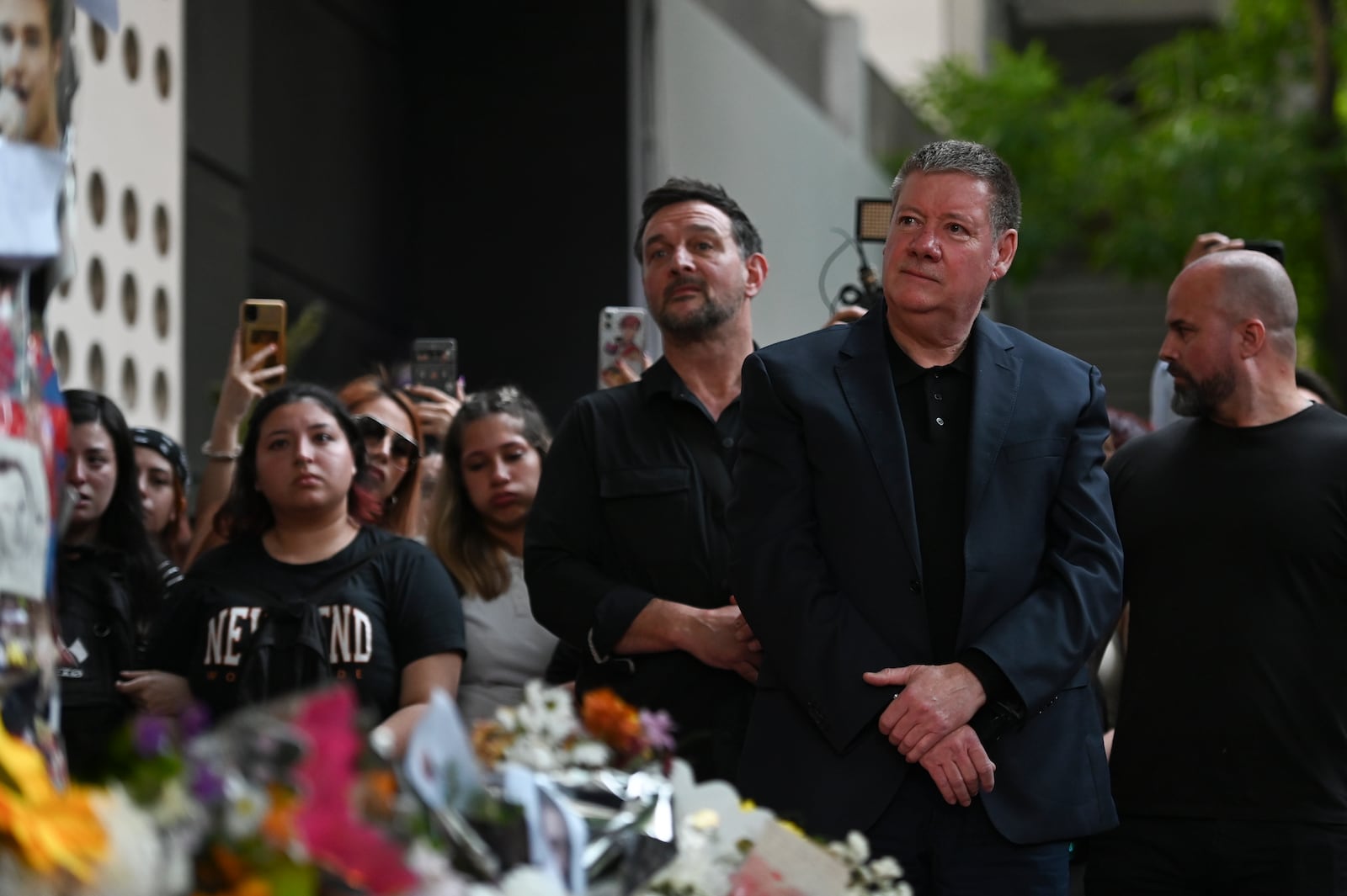 Geoff Payne, right, the father of former One Direction singer Liam Payne, visits a memorial outside the Casa Sur Hotel where the British pop singer fell to his death from a hotel balcony, in Buenos Aires, Argentina, Friday, Oct. 18, 2024. (AP Photo/Mario De Fina)