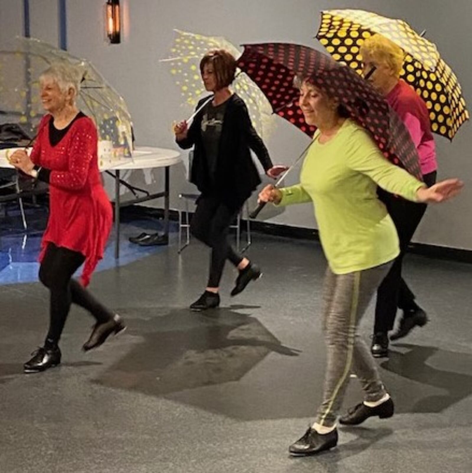 Colorful umbrellas add a little flair to the Senior Sensations’ rehearsal for "Singin’ in the Rain." CONTRIBUTED