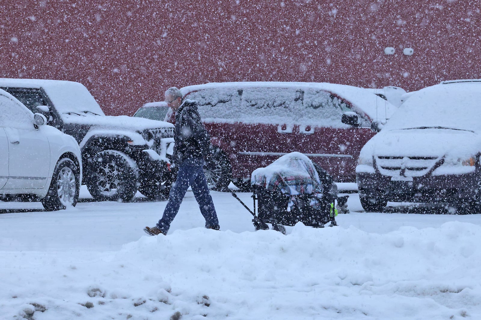 The snow flakes were falling again Friday, Jan. 10, 2025 in Springfield and forecast to add another couple inches onto the snow already on the ground. BILL LACKEY/STAFF