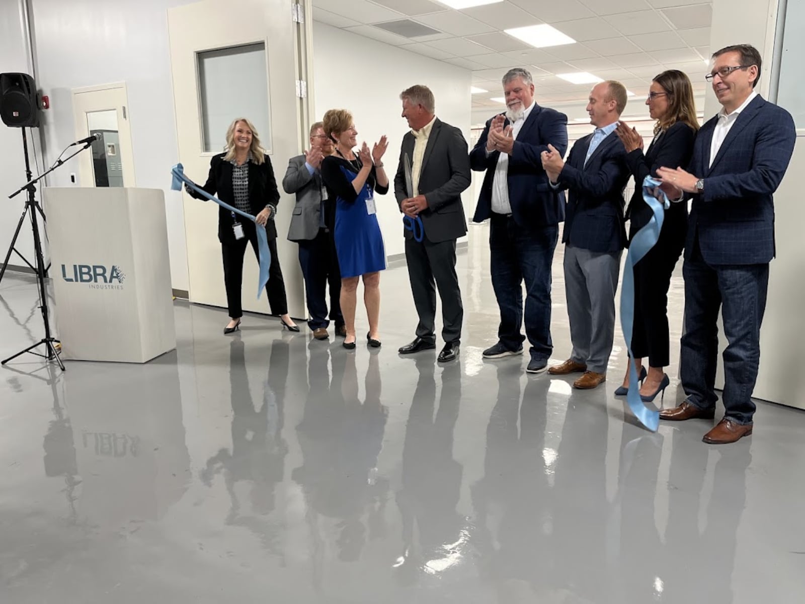 The ribbon is cut: LIbra Industries and Dayton leaders celebrate the opening of a new $1.8 million clean room to support semiconductor fabrication work in Dayton this past August. THOMAS GNAU/STAFF