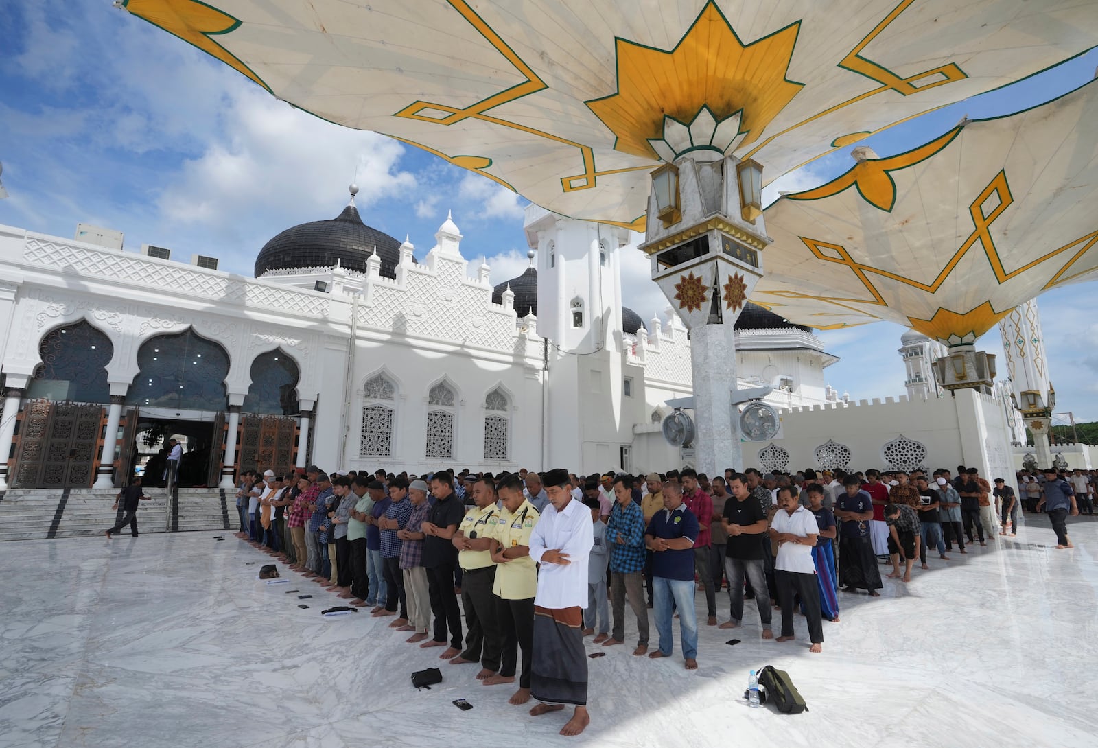 People perform a Friday prayer at Baiturrahman Grand Mosque in Banda Aceh, Indonesia, Friday, Dec. 13, 2024. (AP Photo/Achmad Ibrahim)