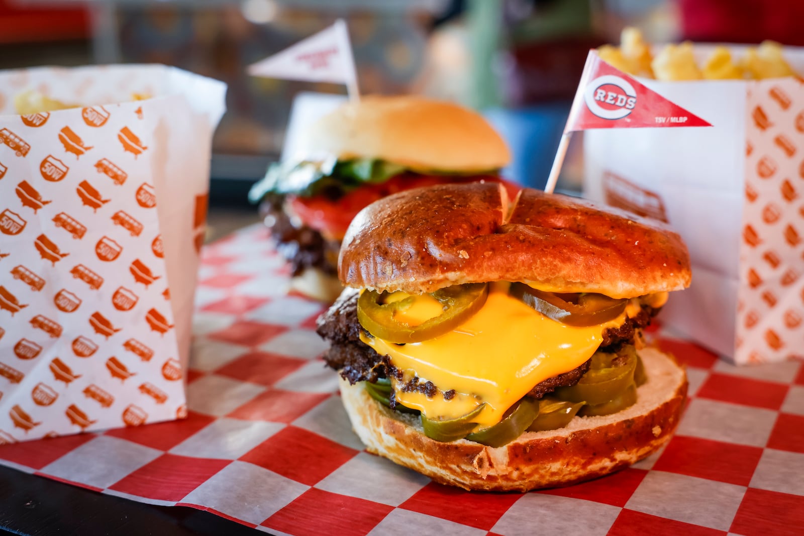 The Cincinnati Reds announced new menu items ahead of opening day on Friday, March 21, 2025 in The Handlebar at the Riverfront Club inside Great American Ball Park in Cincinnati. Executive Chef Gary Davis created a variety of new dishes for the upcoming season. This is the 50 West Soft Pretzel Double cheeseburger. NICK GRAHAM/STAFF