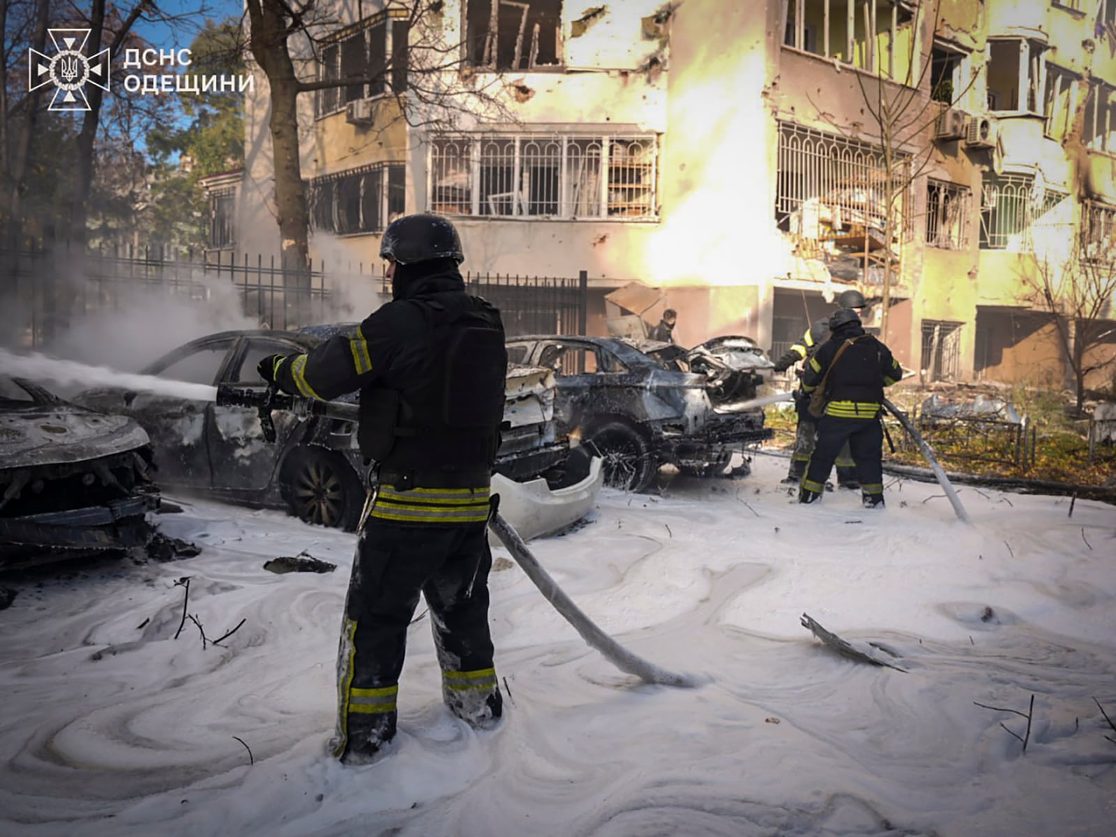 In this photo provided by the Ukrainian Emergency Service, emergency services personnel work to extinguish a fire following a Russian rocket attack in Odesa, Ukraine, Monday, Nov. 18, 2024. (Ukrainian Emergency Service via AP)