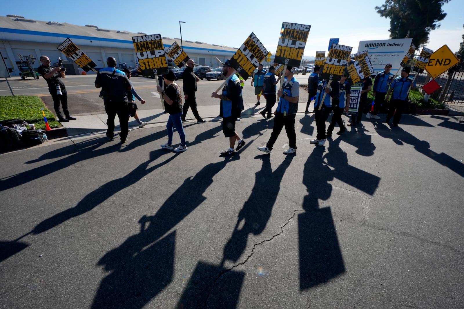 Amazon workers strike outside the gates of an Amazon Fulfillment Center as Teamsters seek labor contract nationwide Friday, Dec. 20, 2024, in City of Industry, Calif. (AP Photo/Damian Dovarganes)