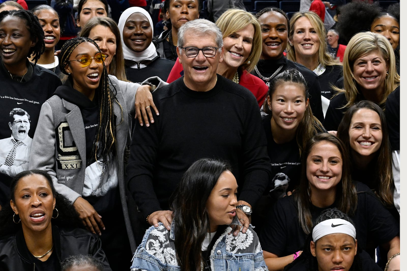 UConn head coach Geno Auriemma poses for a photograph with his players past and present and coaches as he is honored for the most wins in college basketball history, Wednesday, Nov. 20, 2024, in Storrs, Conn. (AP Photo/Jessica Hill)