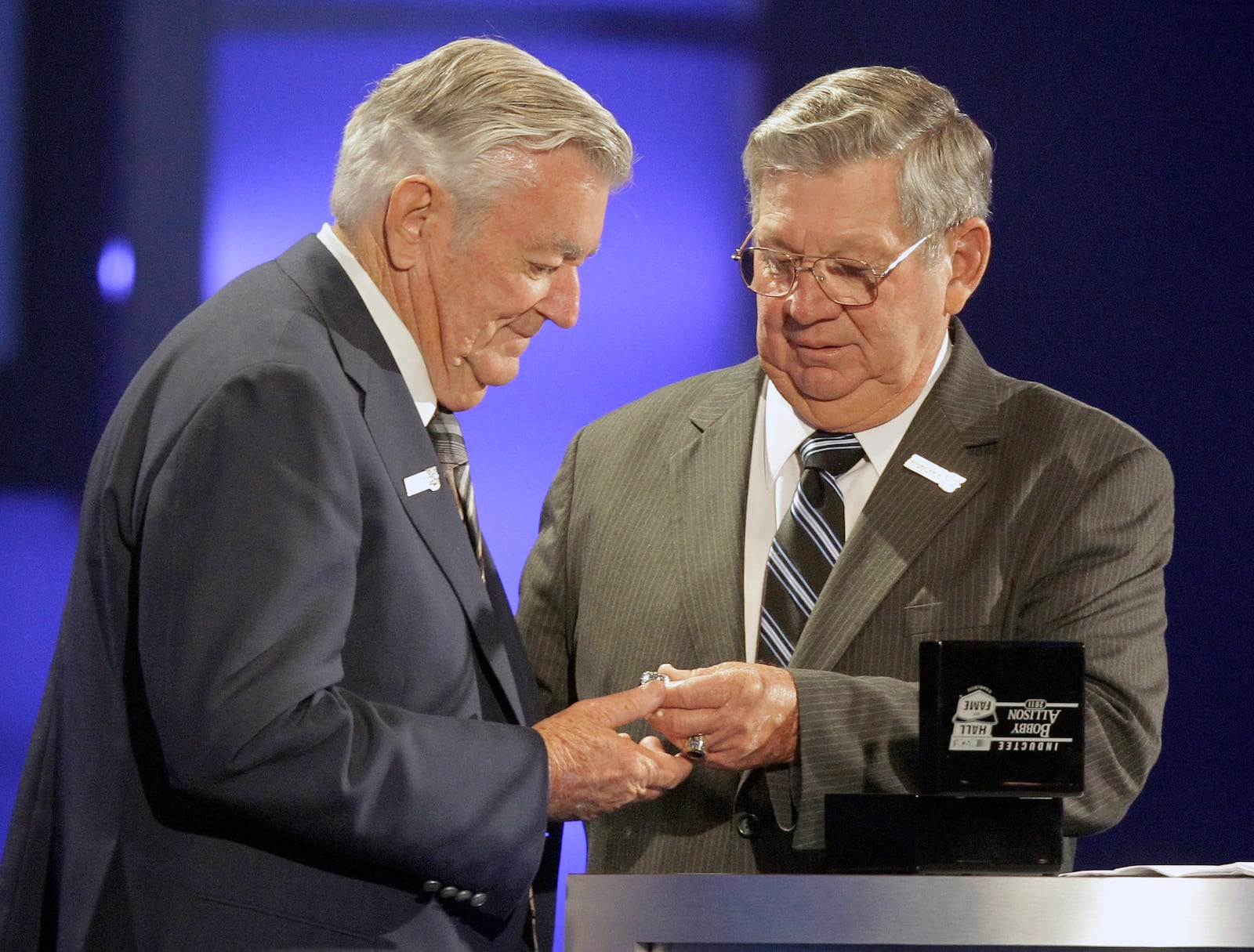 FILE - Bobby Allison, left, is given his ring by brother Donnie Allison, right, as he is inducted into the NASCAR Hall of Fame in Charlotte, N.C., Monday, May 23, 2011. (AP Photo/Chuck Burton, File)