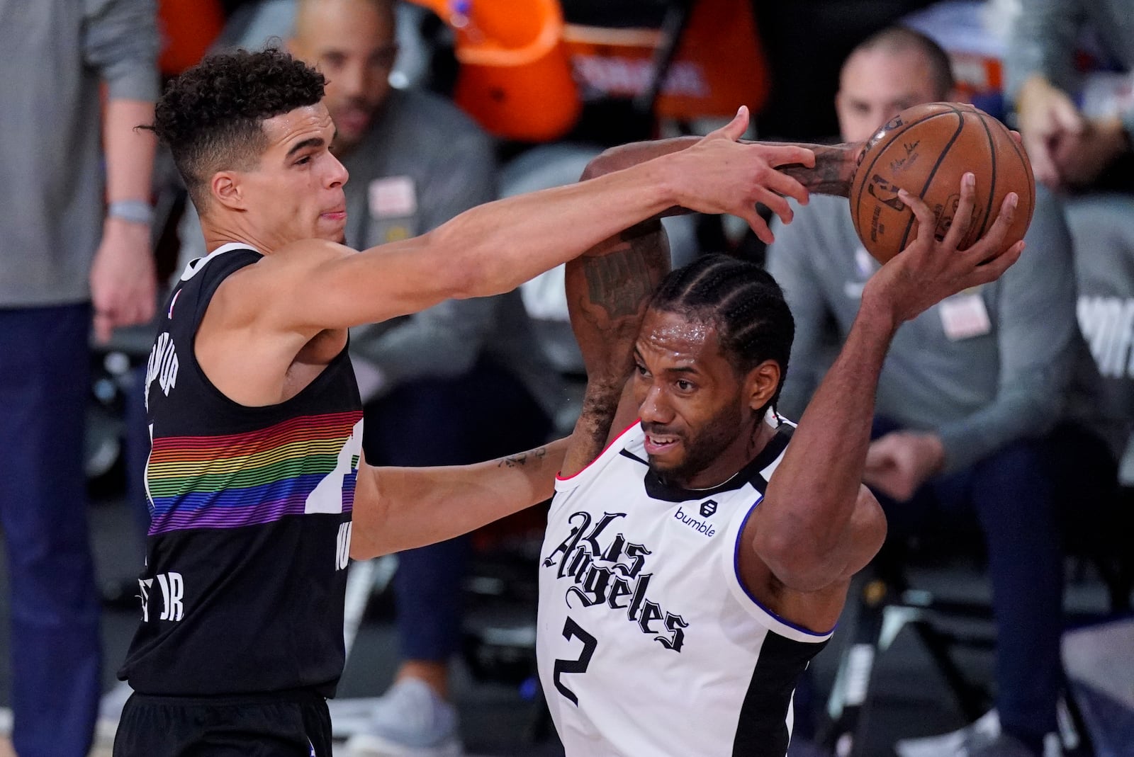 Los Angeles Clippers' Kawhi Leonard (2) is defended by Denver Nuggets' Michael Porter Jr. (1) during the second half of an NBA conference semifinal playoff basketball game, Wednesday, Sept. 9, 2020, in Lake Buena Vista, Fla. (AP Photo/Mark J. Terrill)