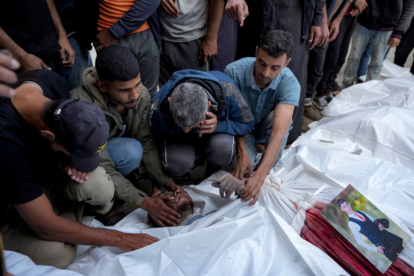 Palestinians mourn their relatives killed in the Israeli bombardment of the Gaza Strip at a hospital morgue in Deir al-Balah, Friday, Nov. 1, 2024. (AP Photo/Abdel Kareem Hana)