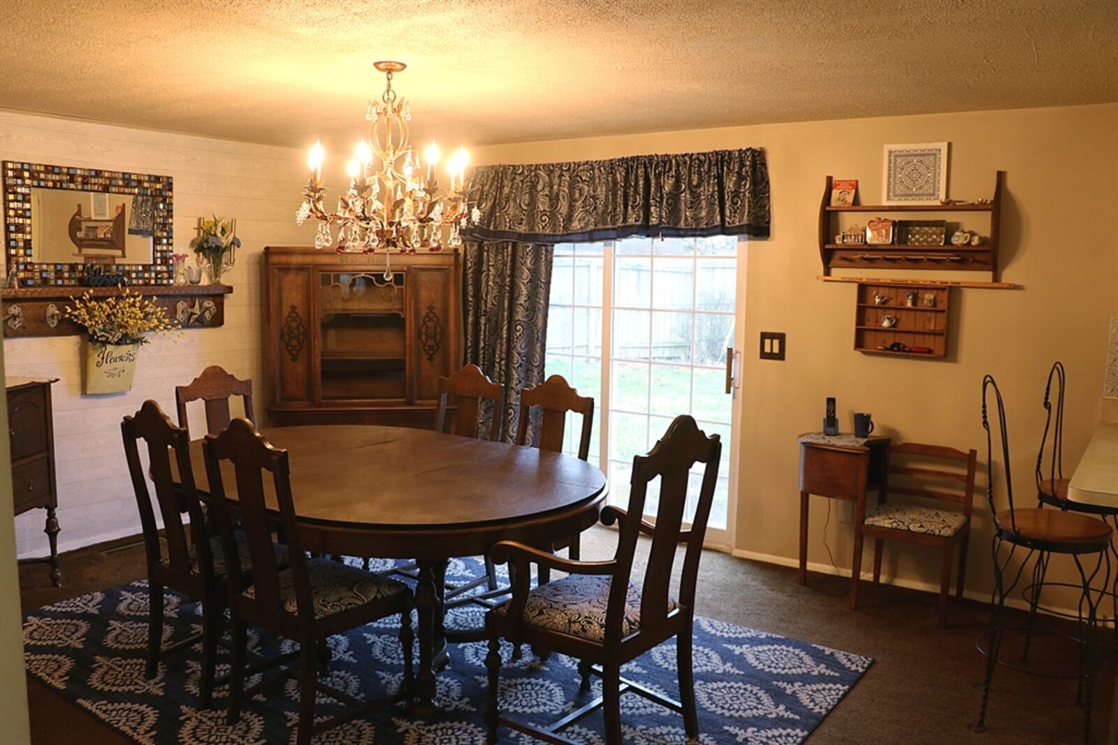 Currently, a crystal chandelier hangs above a large dining room table as the room extends into the kitchen. Contributed by Kathy Tyler 