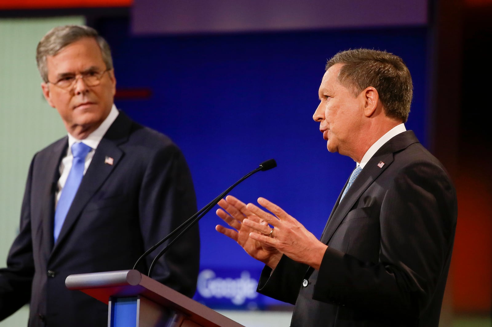 Republican presidential candidate Ohio Gov. John Kasich, right, answers a question as former Florida Gov. Jeb Bush listens during a Republican presidential primary debate, Thursday, Jan. 28, 2016, in Des Moines, Iowa. (AP Photo/Charlie Neibergall)