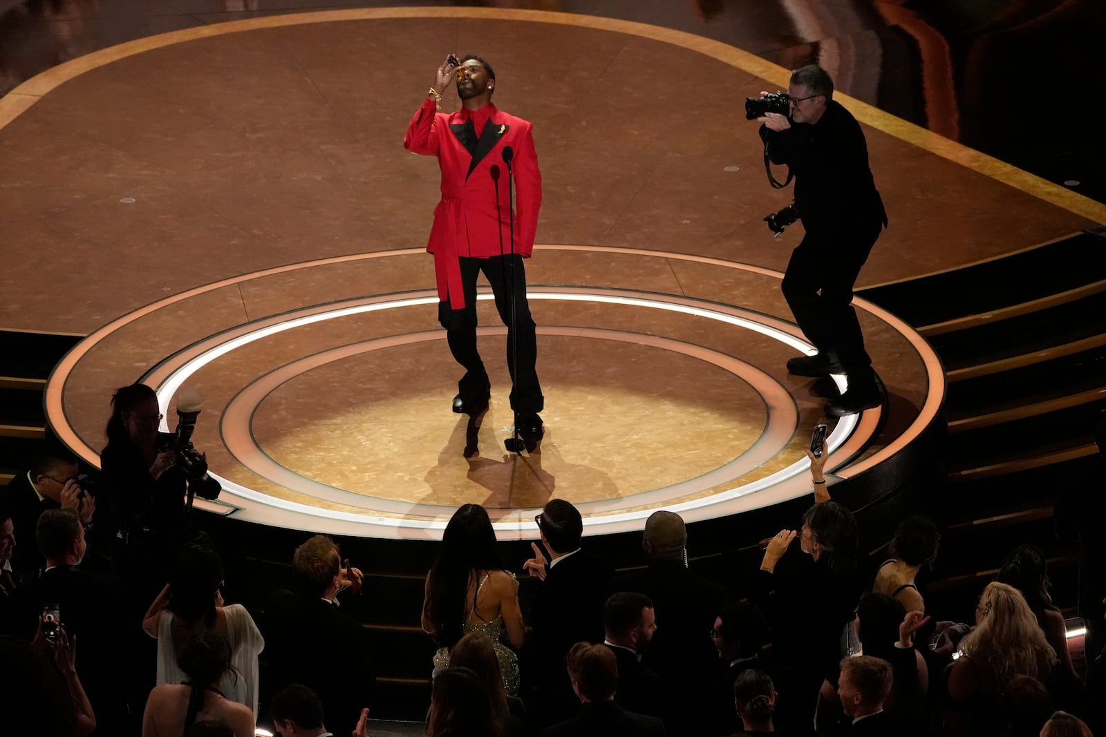 Colman Domingo raises a toast during the Oscars on Sunday, March 2, 2025, at the Dolby Theatre in Los Angeles. (AP Photo/Chris Pizzello)