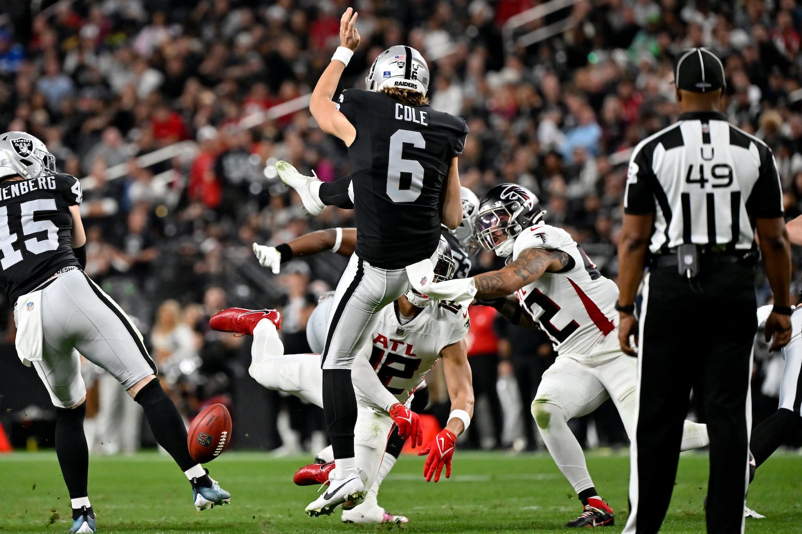 Atlanta Falcons' KhaDarel Hodge (12) blocks the punt of Las Vegas Raiders punter AJ Cole (6) during the second half of an NFL football game, Monday, Dec. 16, 2024, in Las Vegas. (AP Photo/David Becker)