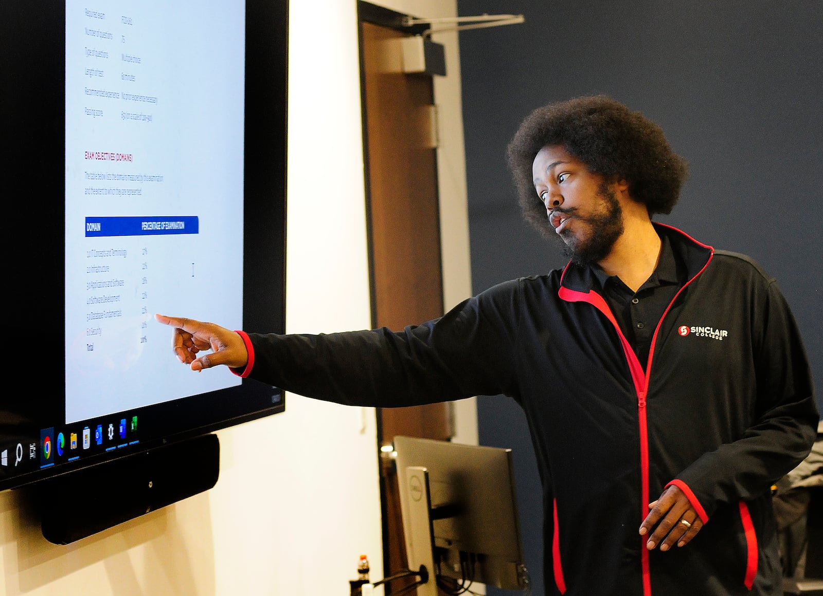 Sinclair Community College instructor, Liban Knight, teaches an Information Technology class Wednesday, Jan. 24, 2024 at the Montgomery County Westown Employment Opportunity Center. MARSHALL GORBY\STAFF