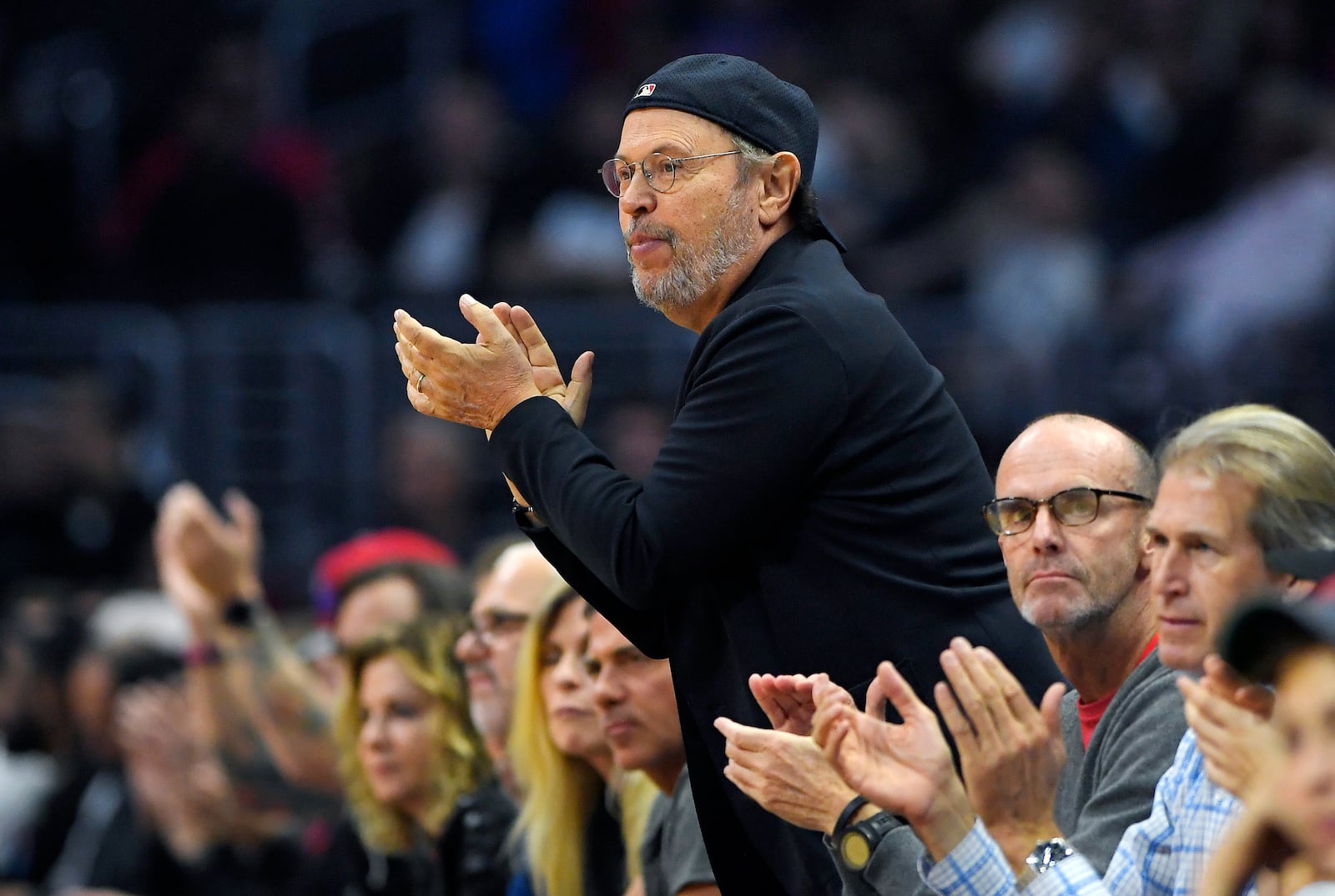 FILE - Actor Billy Crystal claps during the first half of an NBA basketball game between the Los Angeles Clippers and the Detroit Pistons, Monday, Nov. 7, 2016, in Los Angeles. (AP Photo/Mark J. Terrill, File)