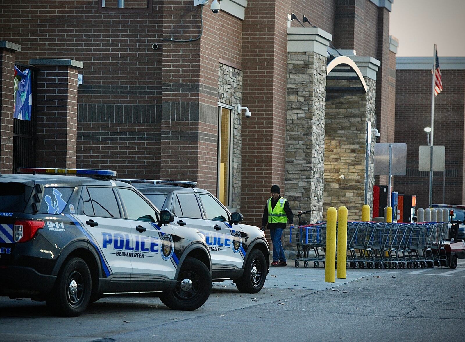 Five police cruisers sit outside the Beavercreek, Walmart on Black Friday, November 24, 2025 the store reopened after a shooting earlier in the week. MARSHALL GORBY \STAFF