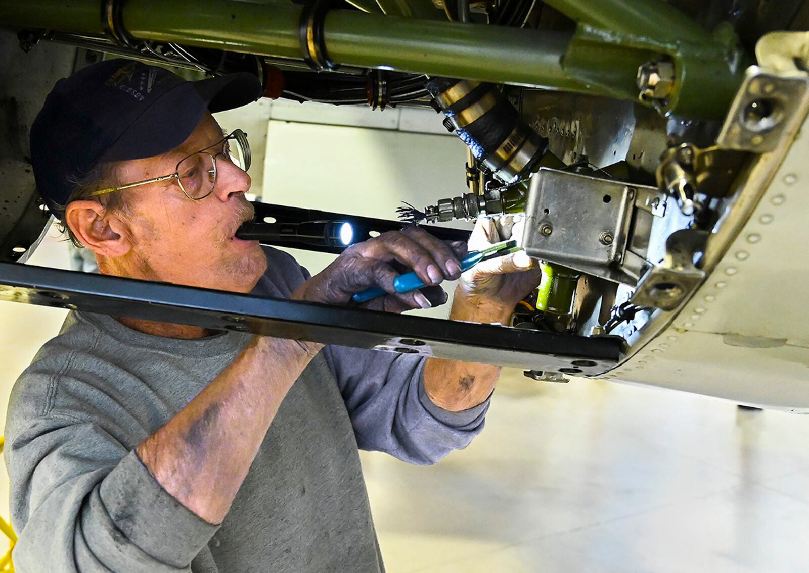 Randy Kemp works in one of the engine cowlings of the Champaign Gal, a World War II-era B-25 bomber, on Feb. 12 at the Champaign Aviation Museum in Urbana. Kemp oversees maintenance on the 78-year-old plane to keep it airworthy. U.S. AIR FORCE PHOTO/R.J. ORIEZ