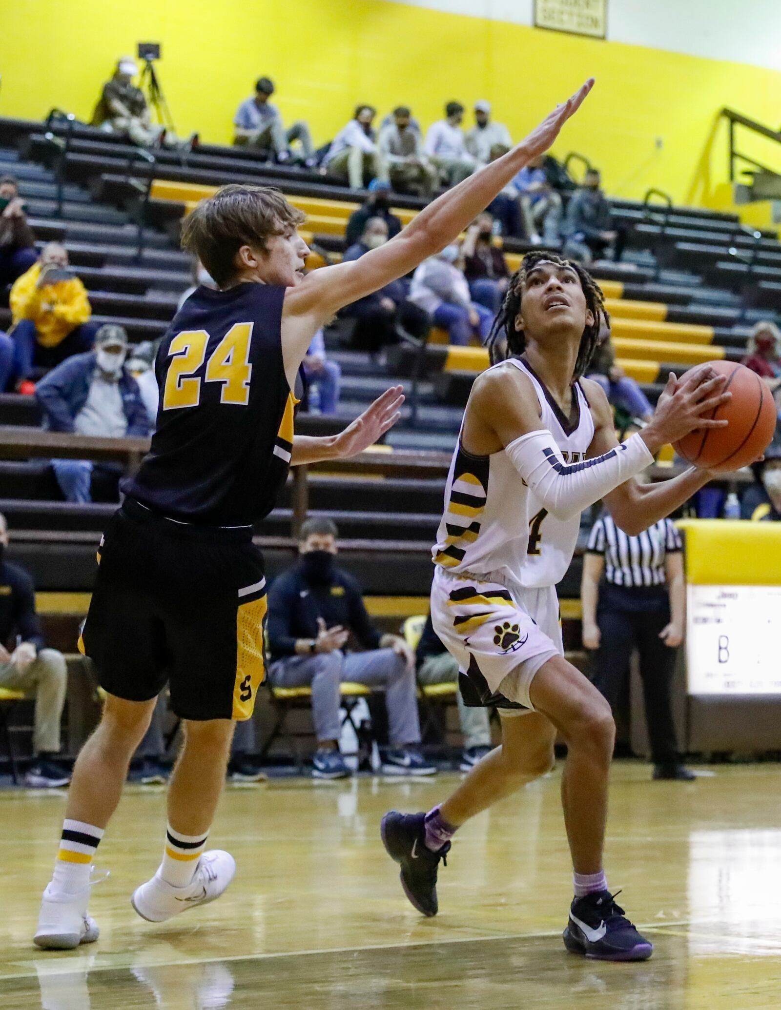 CutlineKR1: Kenton Ridge High School senior Malcolm McKay drives past Shawnee junior Cooper Bair during their game on Friday night in Springfield. The Braves won 74-72 in overtime. Michael Cooper/CONTRIBUTED