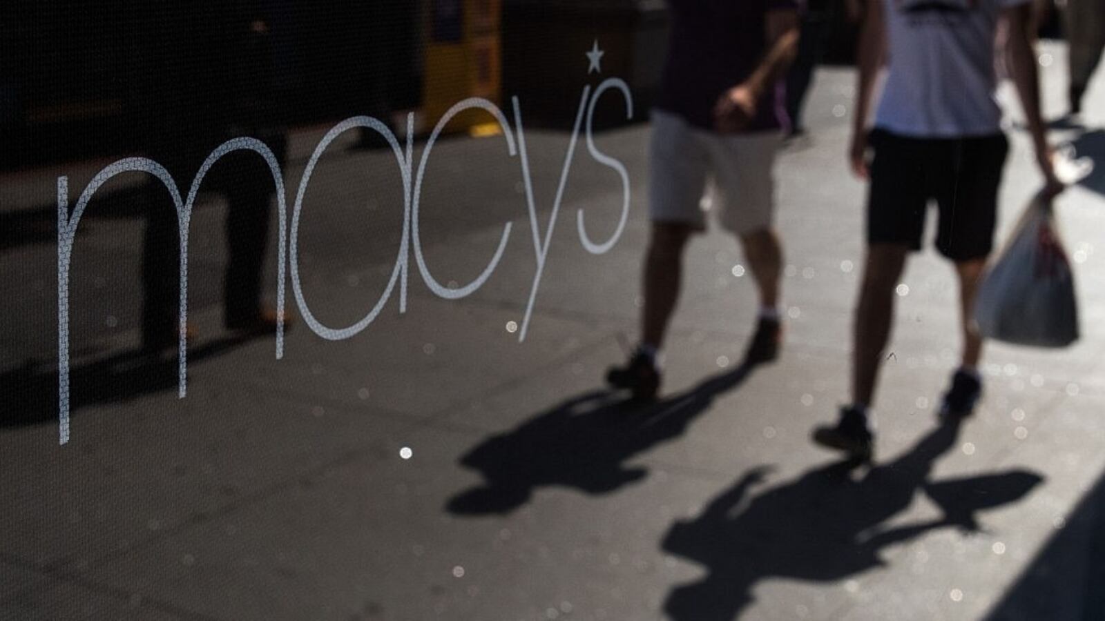 NEW YORK, NY - AUGUST 11: People are reflected in a store window as they walk past Macy's flagship store in Herald Square, August 11, 2016 in New York City.  