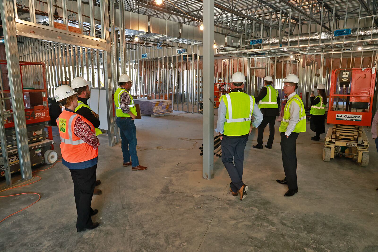 Members of the Global Impact STEM Academy Board of Directors took a tour of the school's new Upper Academy under construction on the Clark State College Leffel Lane campus Tuesday, Oct. 8, 2024. BILL LACKEY/STAFF