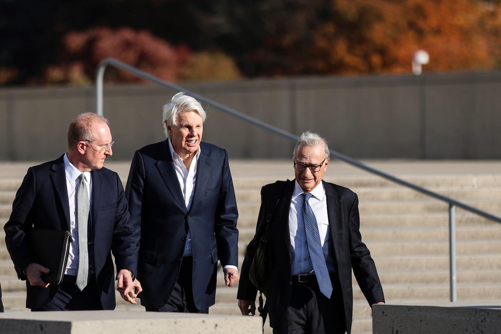 Michael Jeffries, former CEO of Abercrombie & Fitch, center, exits the federal courthouse after his arraignment on sex trafficking and interstate prostitution charges, Friday, Oct. 25, 2024, in Central Islip, N.Y. (AP Photo/Heather Khalifa)