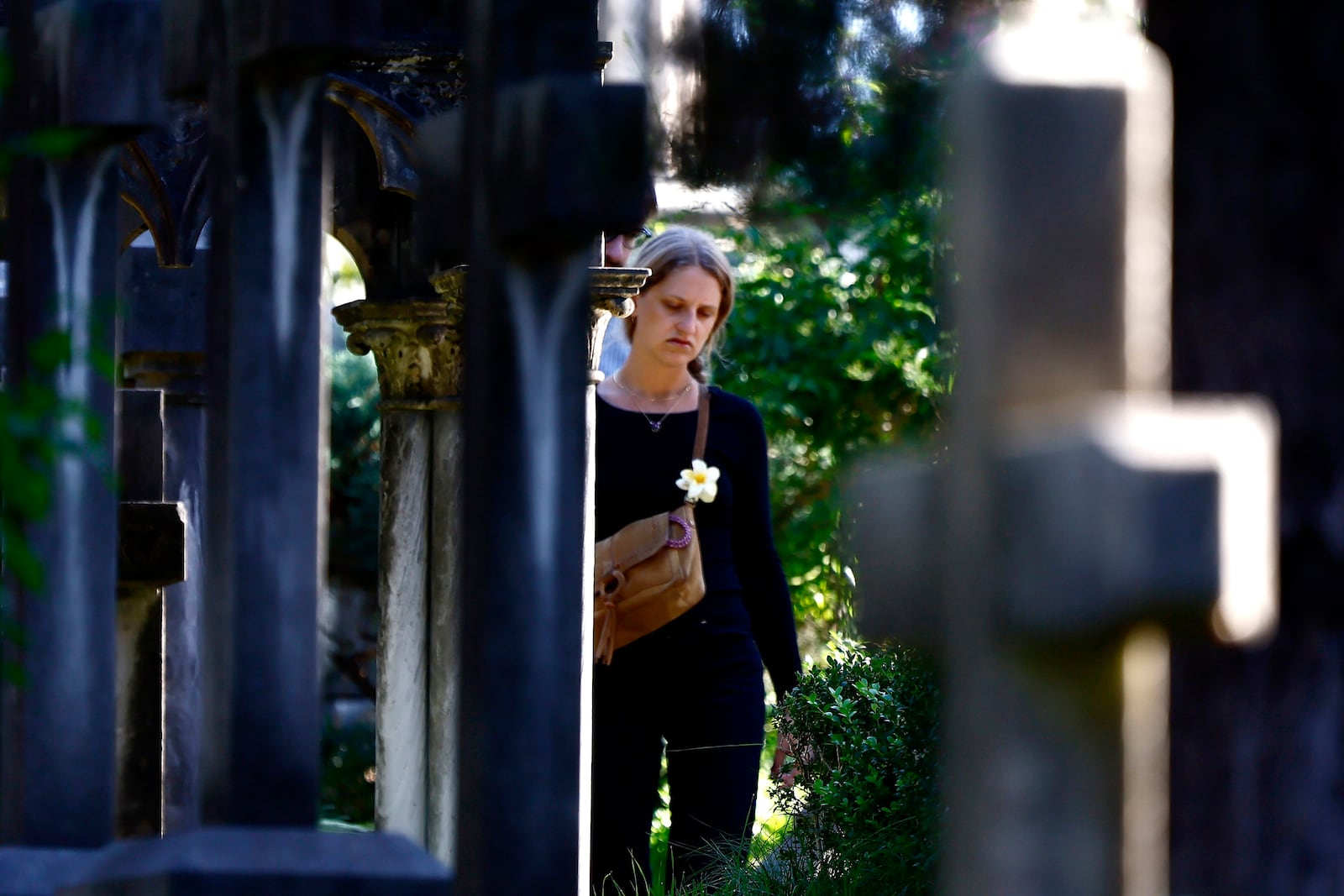 A woman walks in a cemetery on the occasion of All Saints Day, in Rome, Friday, Nov. 1, 2024. (Cecilia Fabiano/LaPresse via AP)